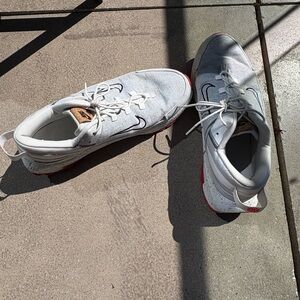 Nike White Athletic Sneakers with Red Outsole Accent